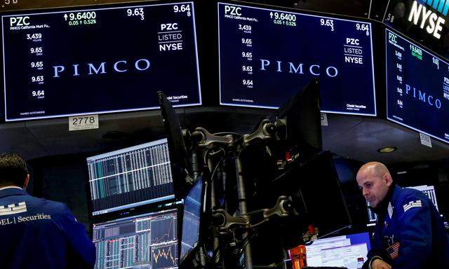 Ticker and trading information for PIMCO are displayed on a screen at NYSE in New York