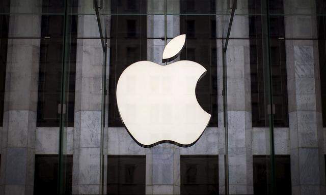 FILE PHOTO - An Apple logo hangs above the entrance to the Apple store on 5th Avenue in the Manhattan borough of New York City