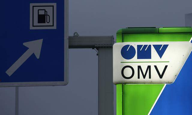 A sign post with the logo of Austrian Energy group OMV is illuminated at a gas station in Vienna