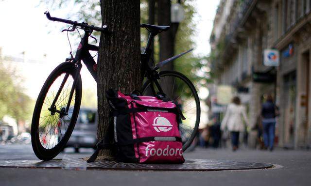 A bicycle and a delivery bag with the logo of Foodora a Berlin-based online food delivery company is seen in Paris