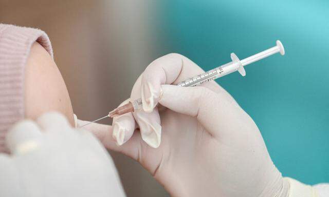 FILE PHOTO: A woman receives a booster dose of Pfizer-BioNTech vaccine against the coronavirus disease (COVID-19) at the Police hospital in Bangkok