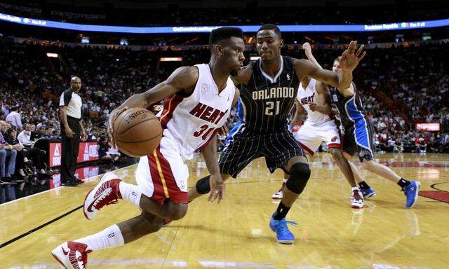 Miami Heat Norris Cole drives past Orlando Magic Maurice Harkless during their NBA basketball game in Miami