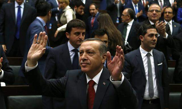 Turkey´s PM Erdogan greets members of the parliament from his ruling AK Party during a meeting in Ankara