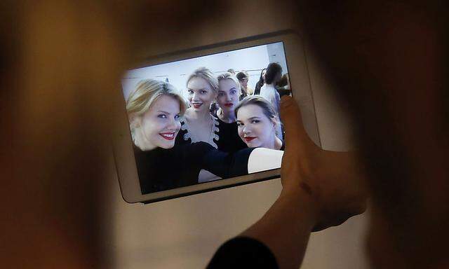 Models take a ´selfie´ photo backstage during Tel Aviv Fashion Week