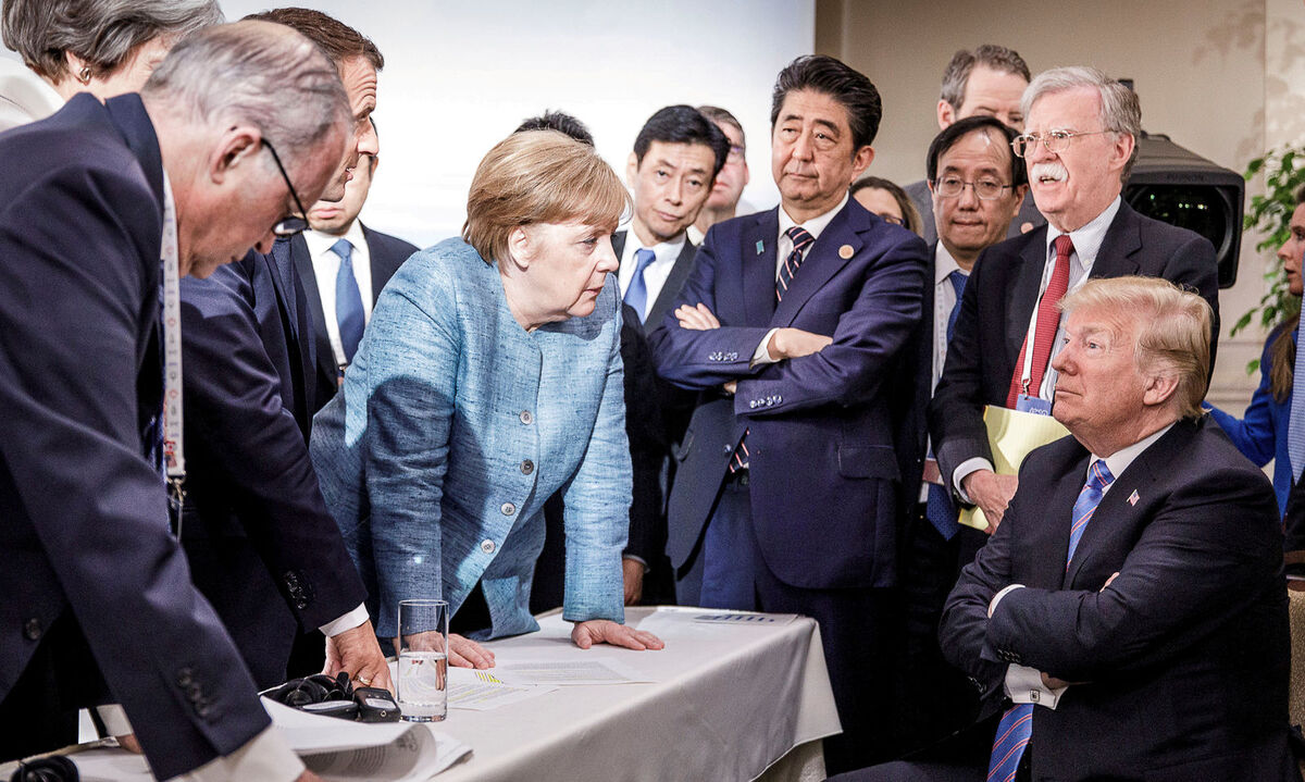 German Chancellor Merkel speaks to U.S. President Trump during the second day of the G7 meeting in Charlevoix city of La Malbaie, Quebec