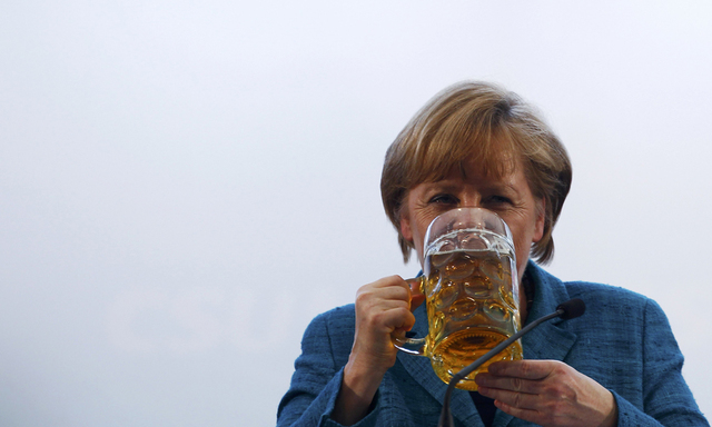 File photo of German Chancellor Merkel drinking a beer after her speech in a beer tent in Munich