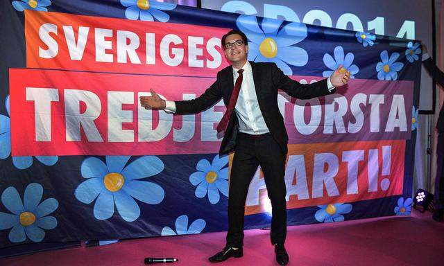 Party leader Jimmie Akesson gestures in front of a poster at the election night party of the Sweden Democrats in Stockholm