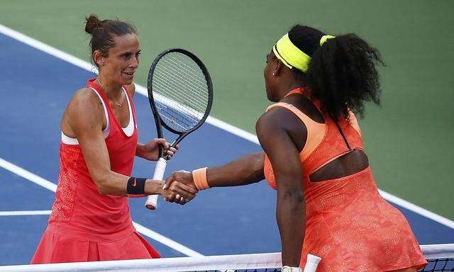 Vinci of Italy shakes hands with Williams of the U.S. after she defeated Williams in their women's singles semi-final match at the U.S. Open Championships Tennis tournament in New York