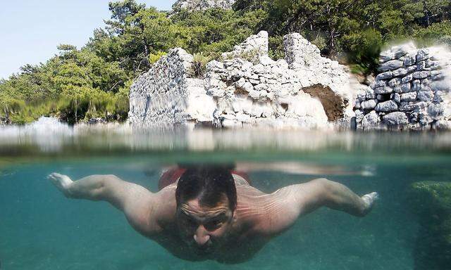 File photo of a tourist swimming in Hamam Koy near Gocek Bay in Mugla province