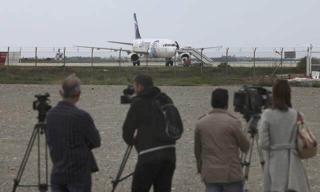 Media gather at Larnaca Airport near a hijacked Egyptair Airbus A320