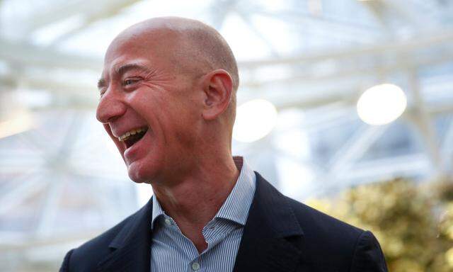 Amazon founder and CEO Jeff Bezos laughs as he talks to the media while touring the new Amazon Spheres during the grand opening in Seattle