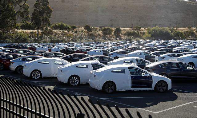 A parking lot of predominantly new Tesla Model 3 electric vehicles is seen in Richmond, California