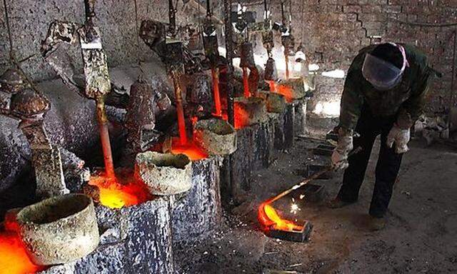 A worker at the Jinyuan Companys smelting workshop pours the rare earth metal Lanthanum into moulds 