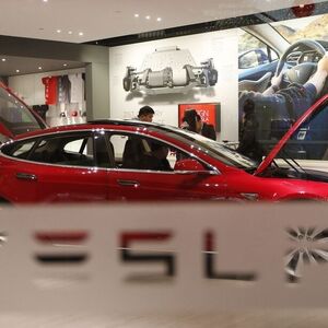 A man looks around Tesla Motors' Model S P85 at its showroom in Beijing