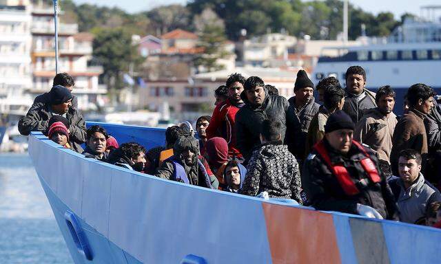 Migrants onboard an EU border agency Frontex boat arrive at the port city of Mytilene on Lesbos island