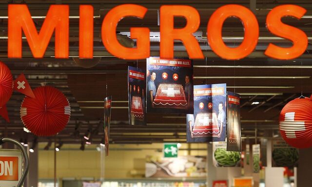 The logo of the supermarket Migros is seen at the entrance of the Shoppyland in Schoenbuehl outside Bern