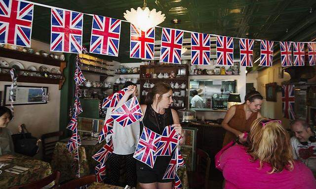 Simmonds hangs Union Jack flags from ceiling of British themed restaurant Tea & Sympathy in preparation for celebrating birth of royal baby in New York