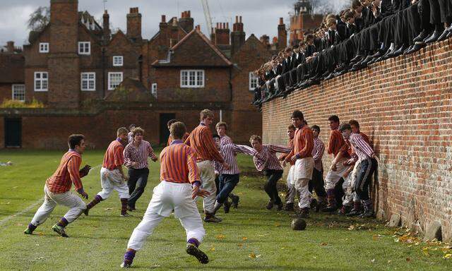 The Collegers and the Oppidans teams compete during the Eton Wall Game at Eton college