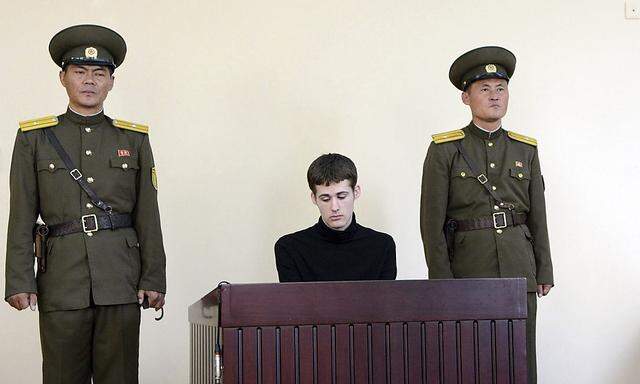 U.S. citizen Matthew Todd Miller sits in a witness box during his trial at the North Korean Supreme Court