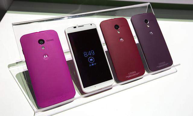 Different colored examples of Motorola´s new Moto X phones rest on a table at a launch event in New York