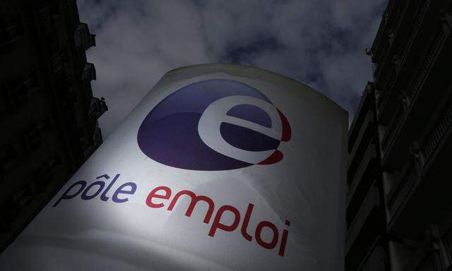 A logo is seen next to the entrance of a Pole Emploi office in Paris