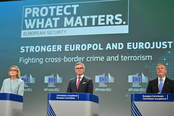 EU Migration Commissioner Magnus Brunner (center) presents the plans to extend the protection status for displaced people from Ukraine in Brussels.
