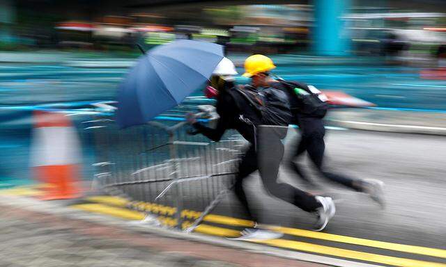 Demonstrators push the barriers during a protest in Hong Kong
