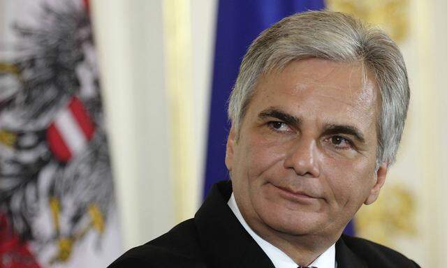 Austrian Social Democrat Chancellor Faymann listens during a news conference after a cabinet meeting in Vienna