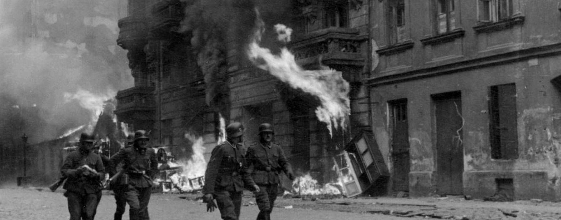 Photograph of a patrol of SS men on Nowolipie Street during the Warsaw Ghetto Uprising Dated 1943 W