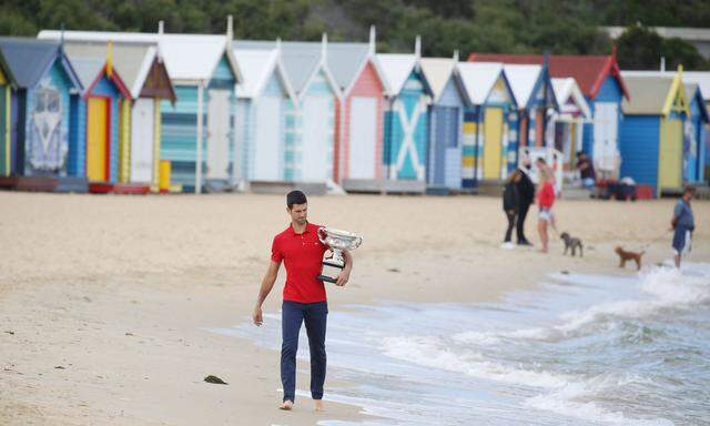 Novak Djokovic, SRB, presenting his trophy after 2021 Australian Open final in Melbourne on Brighton beach, 22/02/2021;