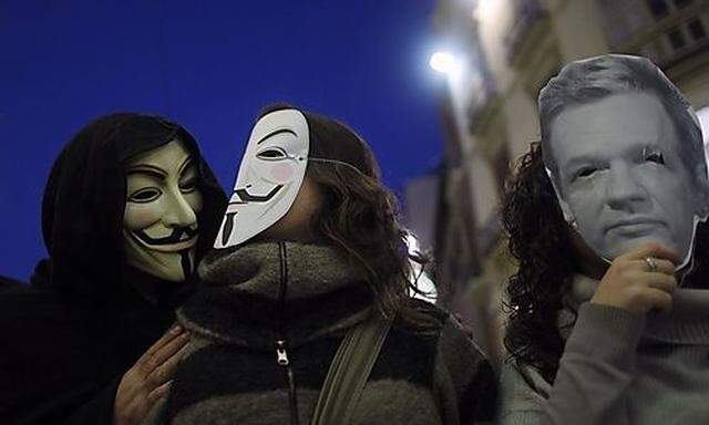 WikiLeaks supporters wear masks during a demonstration in Malaga