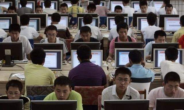 Customers use computers at an internet cafe in Taiyuan, Shanxi province