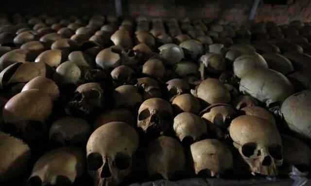 Preserved skulls including those belonging to children are displayed on a metal shelf in a Catholic church in Nyamata