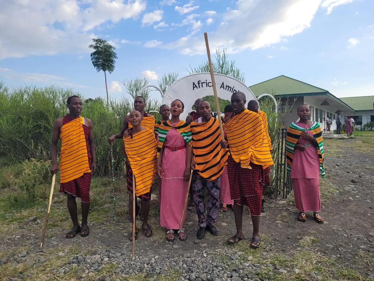 The pupils wear the traditional clothing of the Maasai.