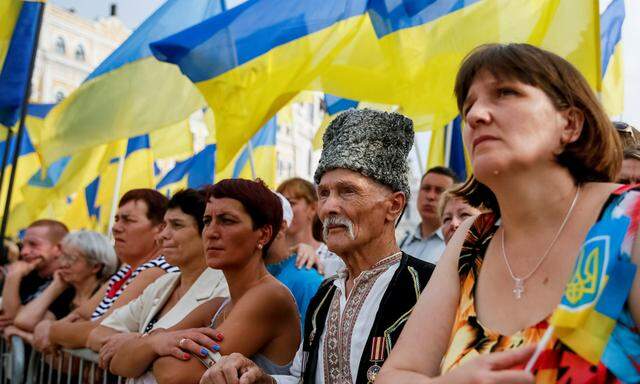 People attend a ceremony marking the Day of the State Flag in Kiev