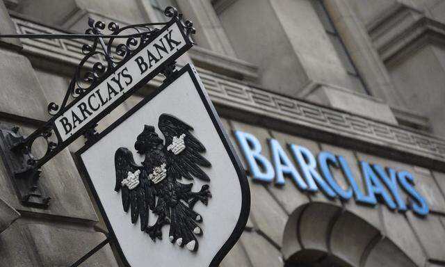 Logos are seen outside a branch of Barclays bank in London