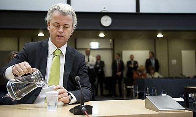 Dutch lawmaker Geert Wilders, charged with inciting hatred against Muslims, pours water in a courtroo