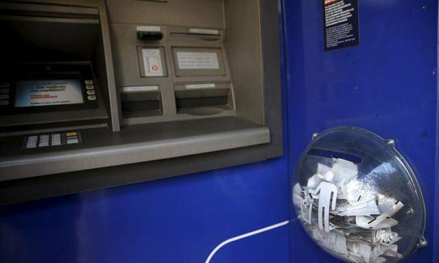 Paper receipts from withdrawals are seen in a litter box at an Eurobank ATM that was emptied by people withdrawing cash, in Athens