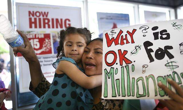 Mendoza protests for higher wages with her daughter Mishelle Cadena  inside a McDonald's restaurant in Oakland,