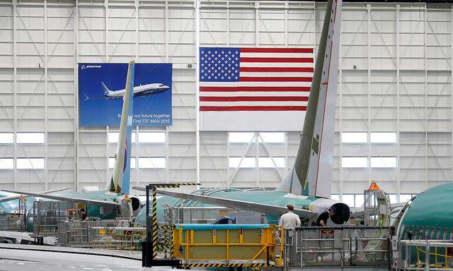FILE PHOTO: Employees work on 737 Max aircraft, seen at the Boeing factory in Renton