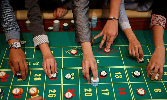 Casino dealers place their bets on a roulette table during training at Solaire Casino in Pasay city, Metro Manila