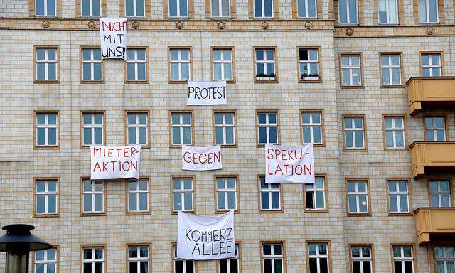 FILE PHOTO: Banners hang from an apartment block on Karl Marx Allee in Berlin to protest against plans to sell flats