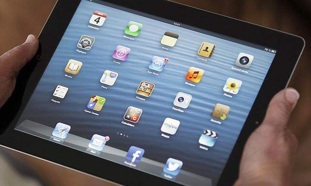 An illustration picture show sapplication icons are displayed on an Apple Ipad tablet held by a woman  in Bordeaux