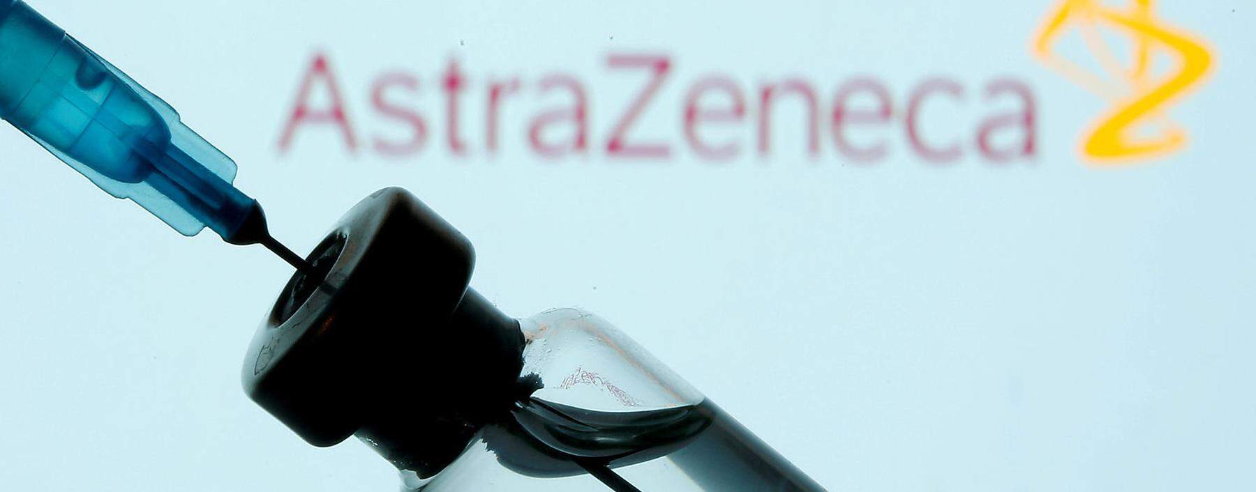 FILE PHOTO: Vial and sryinge are seen in front of displayed AstraZeneca logo