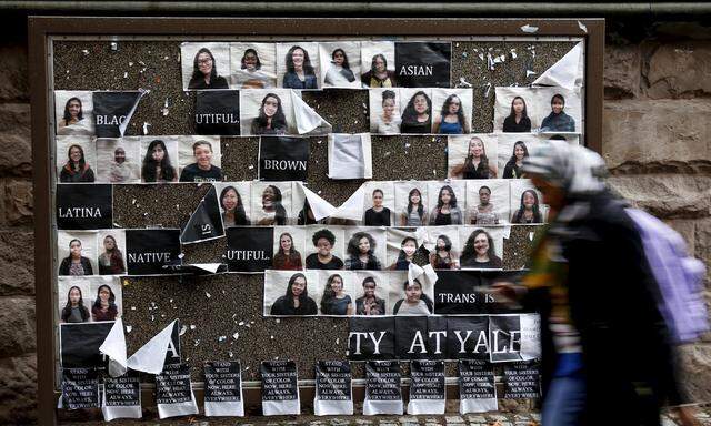 Student walks by a college noticeboard on campus at Yale University in New Haven, Connecticut