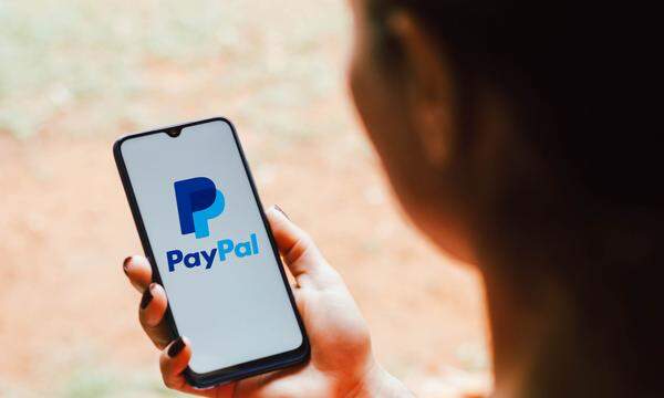 In this photo illustration the PayPal logo seen displayed on