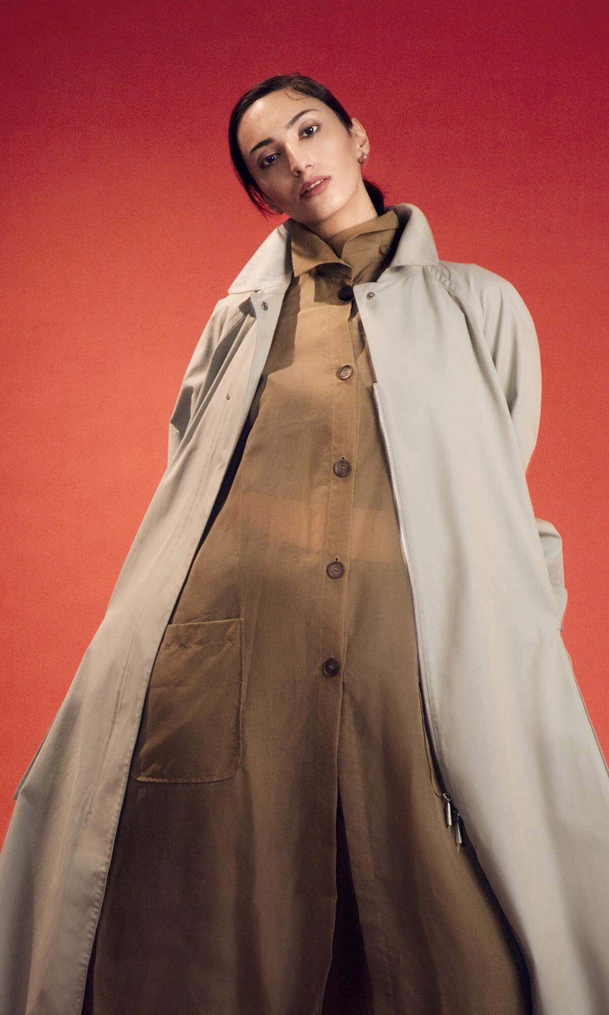 Salvatore Ferragamo. Mihriban trägt eine Bluse aus Seidenorganza, ein Top aus Seidenstretch und einen Oversizemantel aus Baumwollgarbadine.