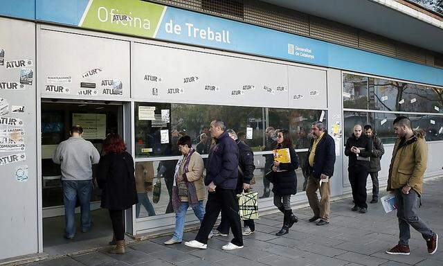 People line up at an employment office in Badalona, near Barcelona