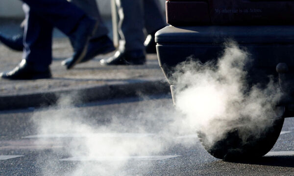 FILE PHOTO: An exhaust pipe of a car is pictured on a street in a Berlin