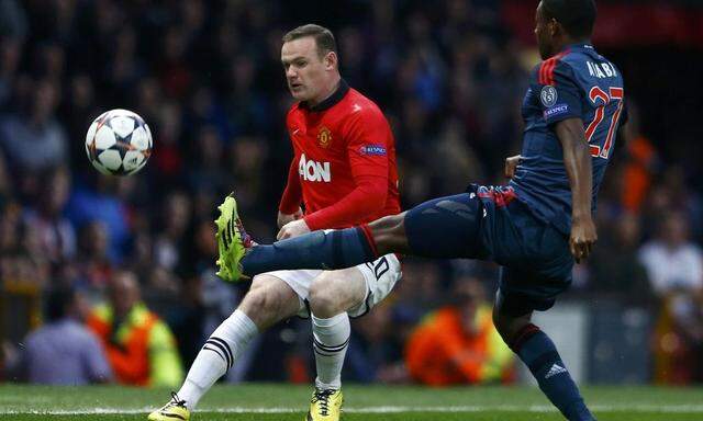 Manchester United's Rooney fights for the ball with Bayern Munich's Alaba during their Champions League quarter-final first leg soccer match at Old Trafford in Manchester